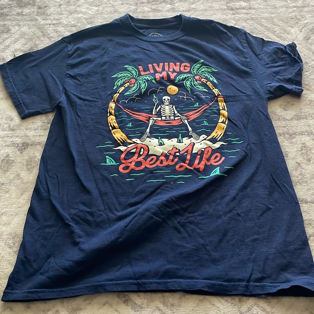 Medium blue T shirt with skeleton on beach living my best life picture on front